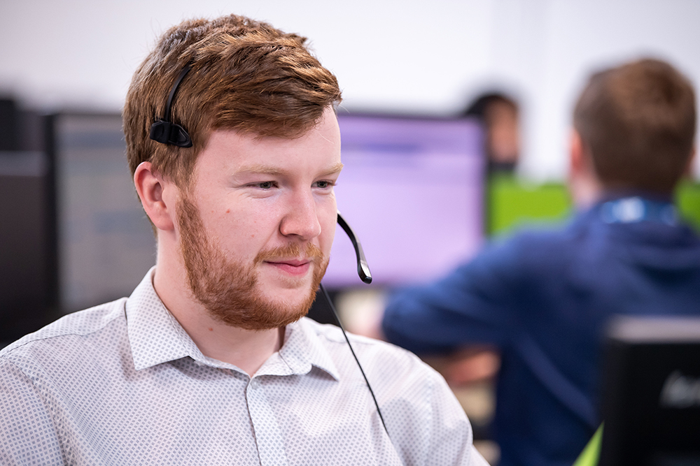 Service Desk colleague with a headset on.