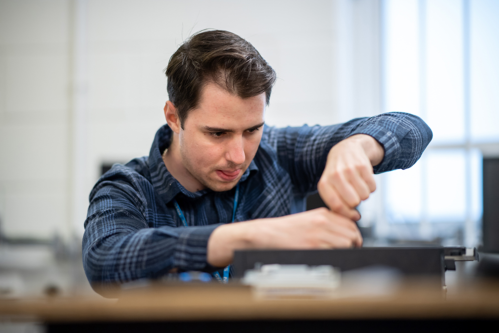 Technician working on a computer build.